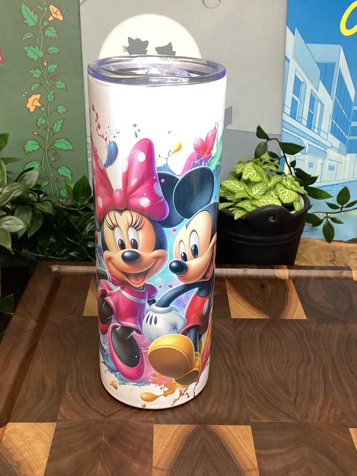 Tumbler with cartoon characters on a wooden surface